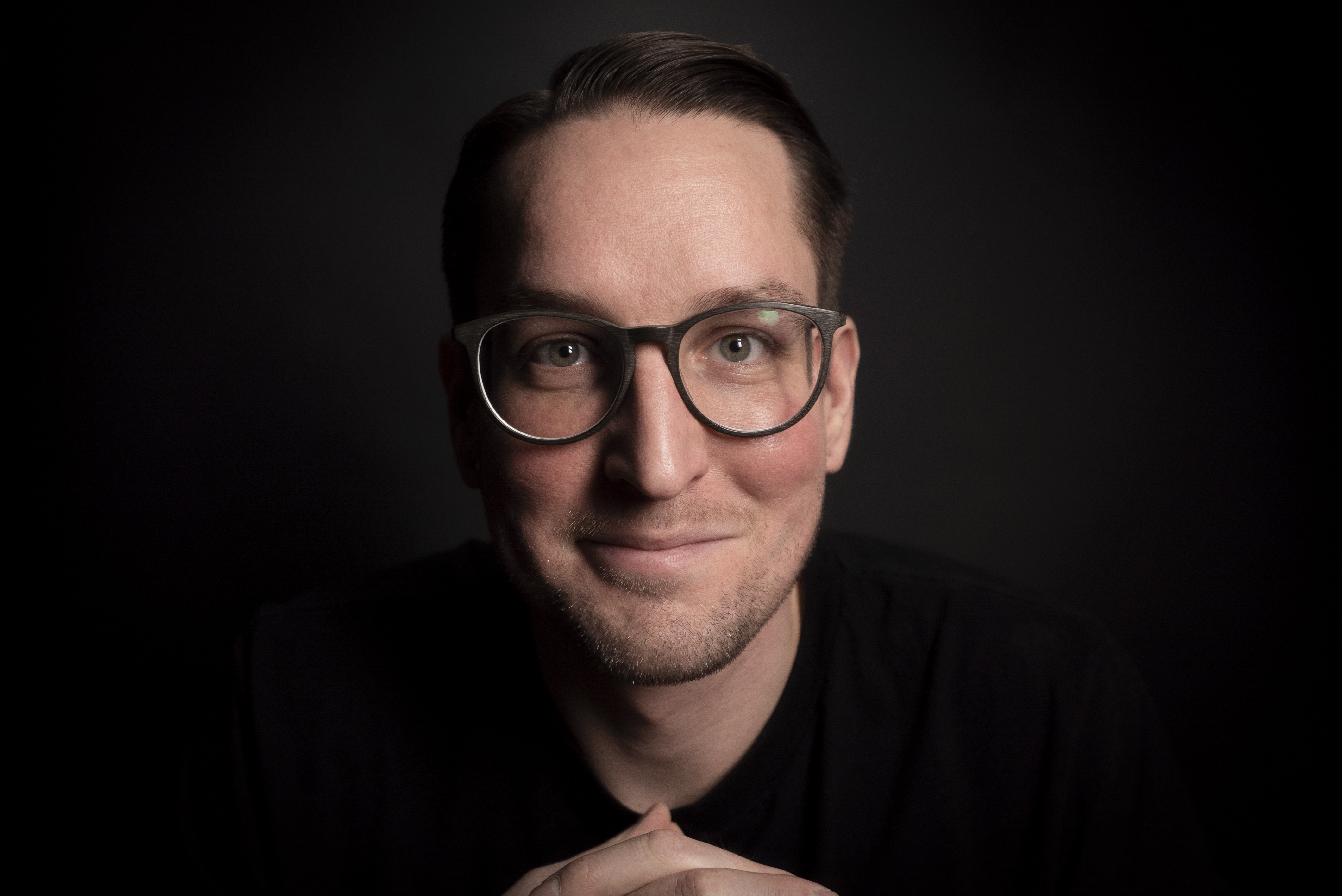 picture of a guy with glasses and black shirt