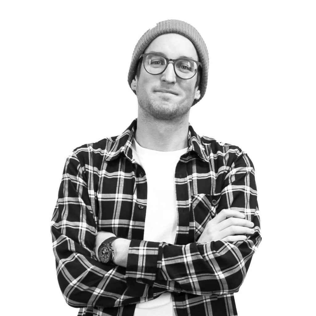Video Production Company portrait picture of a guy with a hat and glasses with his arms crossed